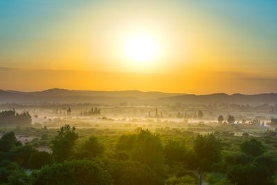 Scenic view of landscape against sky during sunset