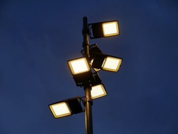 Low angle view of illuminated lamp against clear sky