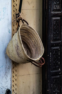 Close-up of hat hanging on wall