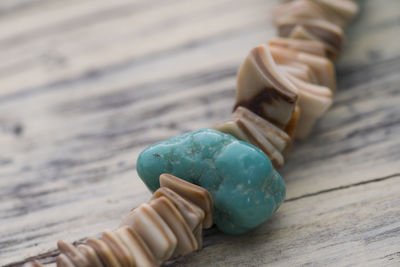 High angle view of stone bracelet on table