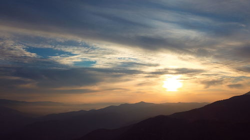 Scenic view of silhouette mountains against sky during sunset