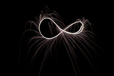 Close-up of illuminated light painting against black background