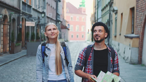 Happy young woman on street in city