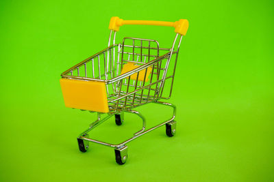 Close-up of empty chairs against green background