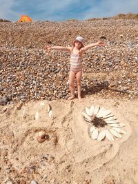 Full length of girl standing on sand at beach