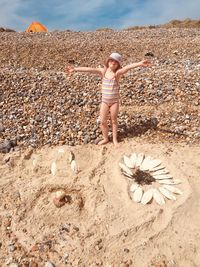 Full length of girl standing on sand at beach