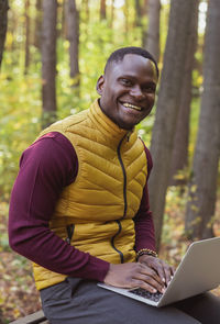 Young man using laptop at park