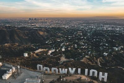 Aerial view of townscape against sky at sunset