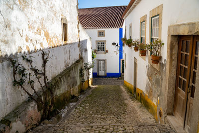 Empty alley amidst buildings in city