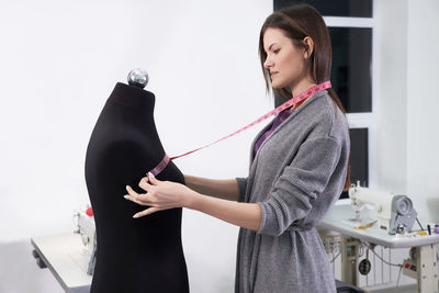Woman measuring clothes