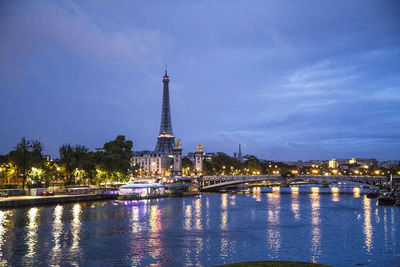 Illuminated buildings in city at waterfront