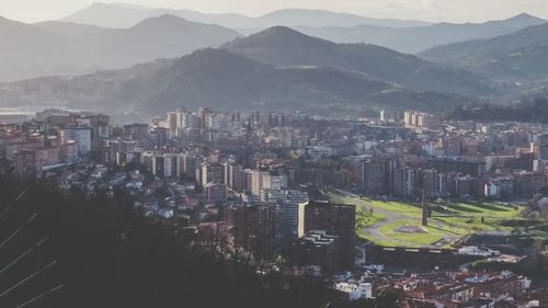 Cityscape with mountain range in background