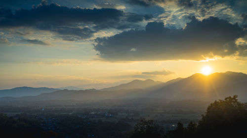 Scenic view of silhouette mountains against sky at sunset