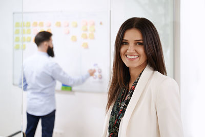 Portrait of young businesswoman standing in clinic