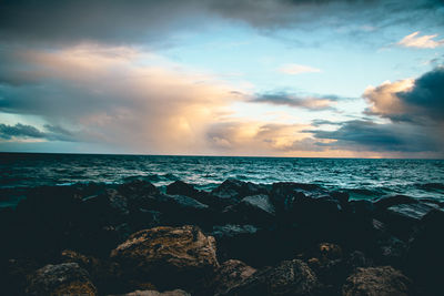 Scenic view of sea against sky at sunset