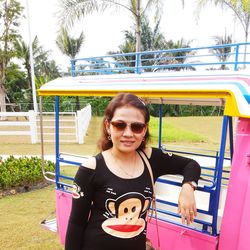 Portrait of smiling young woman sitting outdoors