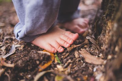 Low section of man holding hands on land