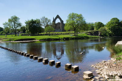 Arch bridge over lake against sky