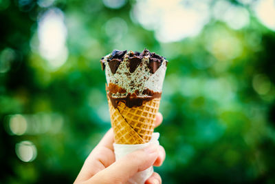 Close-up of hand holding ice cream cone