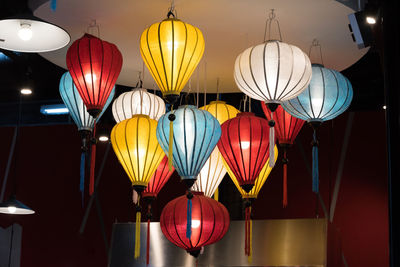 Low angle view of illuminated lanterns hanging at night