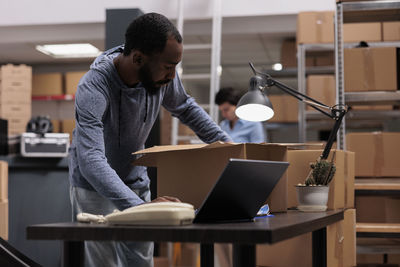 Side view of man working at table