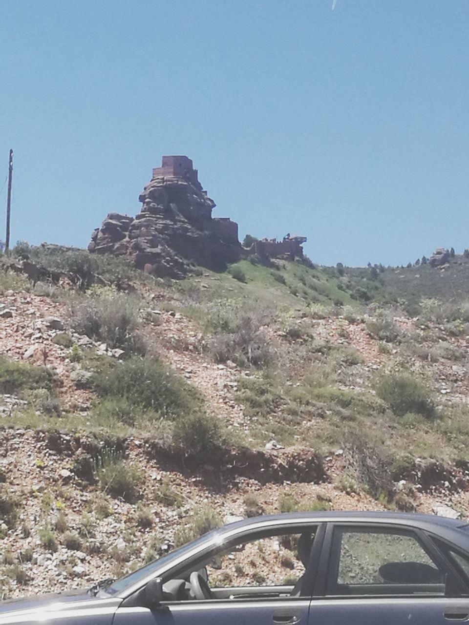 BUILT STRUCTURE ON ROAD AGAINST CLEAR SKY