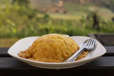 Close-up of fried egg with spoon and fork