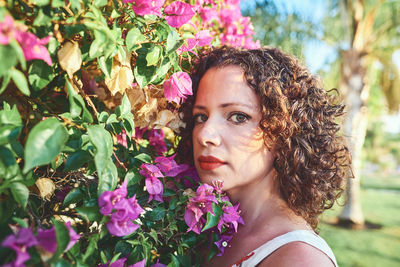 Portrait of beautiful woman with pink flower