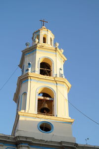 Low angle view of bell tower against sky