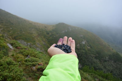 Man standing on mountain against sky