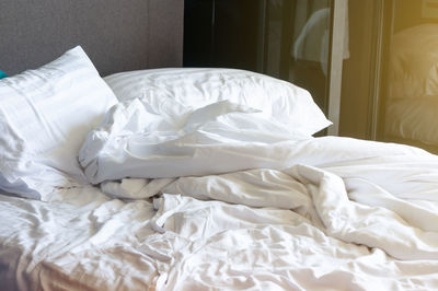 Close-up of white blanket on bed at home