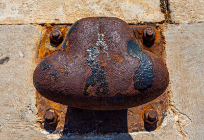 Close-up of rusty metal against wall