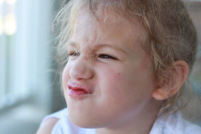 Close-up portrait of cute girl looking away