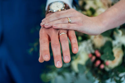 Midsection of couple holding hands