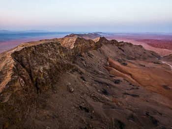 View of rocky beach against cloudy sky