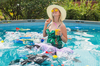 Full length of woman holding swimming pool