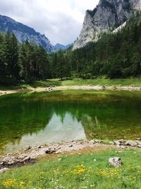 Scenic view of lake and mountains against sky