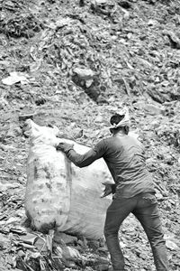 Rear view of man working on field