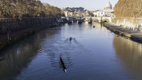 Rowers on the river tiber in rome, italy.