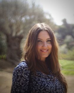 Portrait of smiling young woman standing outdoors