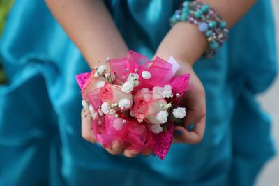 Midsection of bride holding bouquet