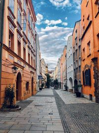 Empty alley amidst buildings in city