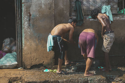 Rear view of people standing outdoors