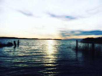 Scenic view of lake against sky during sunset