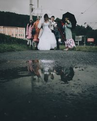 Group of people with reflection in water