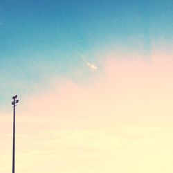 Low angle view of street light against blue sky