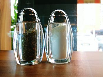 Salt and pepper shakers on table at restaurant