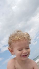 Portrait of happy boy against sky