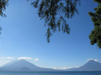 Scenic view of mountains against clear blue sky