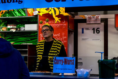 Full length of man standing in store